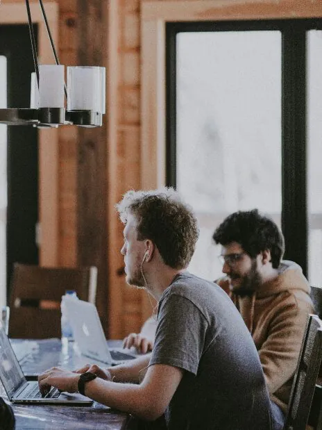 Foto zweier arbeitenden Personen am Laptop