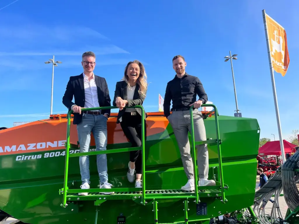 Foto von drei Personen auf einer Landwirtschaftsmaschine